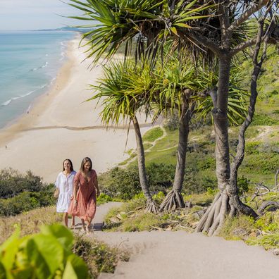 Two ladies walking along a track at Sunshine Beach