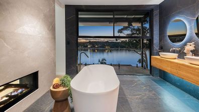 Bathroom view luxury bath tub design fireplace views Brisbane river