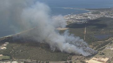 There are 100 firefighters on the scene, trying to contain an out-of-control bushfire threatening lives and homes in the southwest of Perth.