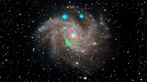 Scientists at NASA are perplexed by what made this distant galaxy glow blue and green.