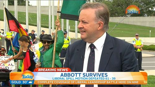 One protester takes advantage of the camera's position. (9NEWS)