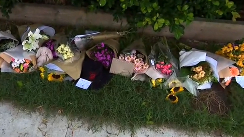 Flowers are being left outside the house where Max Chirila lost his life. 