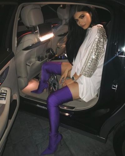 Kylie is careful to cover-up with the purple latex boots from Balenciaga offering minimal protection.