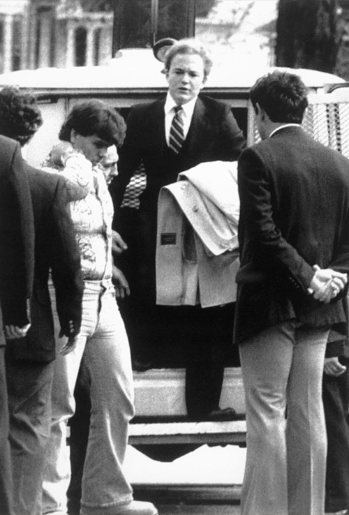 Arne C. Johnson, with a coat over arm, steps from a police van on arrival at court in Danbury for the opening day of his trial. 