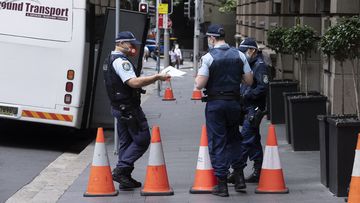 Police officers pictured outside one of the Sydney quarantine hotels.