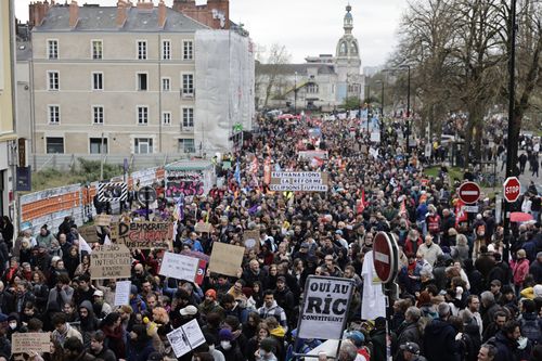 Demonstrators march Thursday, April 6, 2023 in Nantes, western France. 