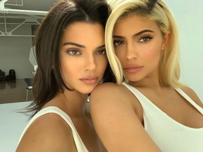 Kendall Jenner and Kylie Jenner pose in matching white sports bras during a photo shoot of new looks in their Kendall + Kylie clothing collection, 30, October, 2018.