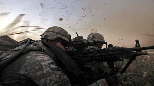 In this 2011 photo, US soldiers from 1st Battalion, 18th Infantry Regiment are bathed in rotor wash moments after arriving by Blackhawk helicopter in Iraq.