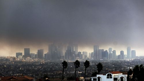 Thick heavy smoke from wildfires shrouds downtown Los Angeles on Wednesday, Jan. 8, 2025. (AP Photo/Richard Vogel)