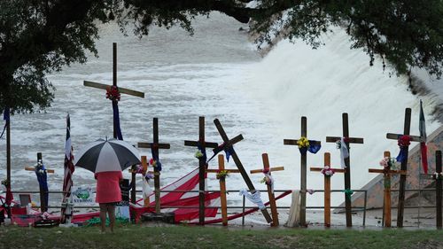 Rain falls over a make-shift memorial for flood victims along the Guadalupe River, Sunday, July 13, 2025, in Kerrville, Texas.