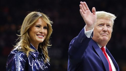 President Trump escorts Melania off the field prior to the College Football Playoff National Championship Game on January 13, 2020.