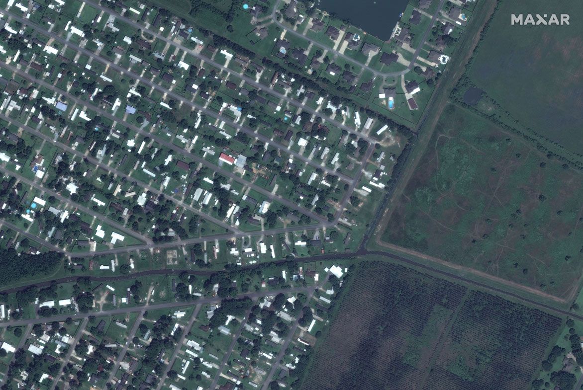 In this before photo, a community of mobile homes along Flounder Drive and Tuna Lane are seen.