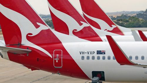 Baggage is loaded onto a Qantas jet at Melbourne Tullamarine Airport. 