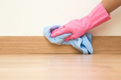 Cleaning skirting boards with a microfibre cloth