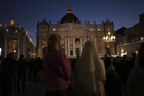 People gather in St Peter's Square as they wait to see the smoke billow from the chimney of the Sistine Chapel in St Peter's Square during the cardinals' conclave to elect a new pope, at the Vatican, Wednesday, May 7, 2025.