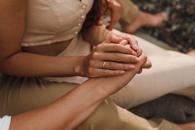 Couple holding hands at wedding