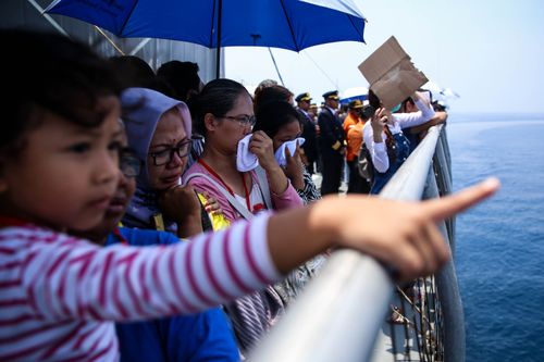 Attendees gathered on the deck of a ship that was ferried out to the crash site where Lion Air flight JT-610 plunged into the ocean at high speed.