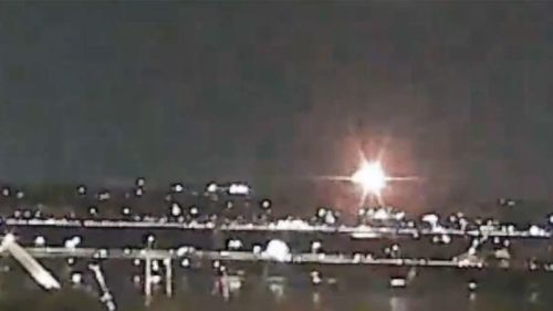 A flash of light captured on a webcam appears to be a plane collision in Washington DC.