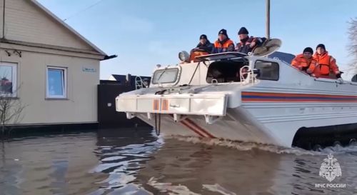 In this grab taken from a video released by the Russian Emergency Ministry Press Service on Saturday emergency workers aboard an amphibious vehicle look to evacuate local residents. (Russian Emergency Ministry Press Service via AP)