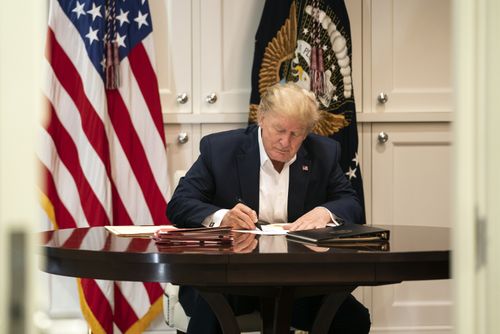 In this image released by the White House, President Donald Trump works in the Presidential Suite at Walter Reed National Military Medical Centre. (Joyce N. Boghosian/The White House via AP)
