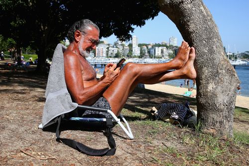 Ed Sciberras relaxes in the shade at Red Leaf Beach, in Sydney, this afternoon.