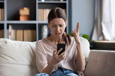 Confused angry woman texting. woman looking at phone.