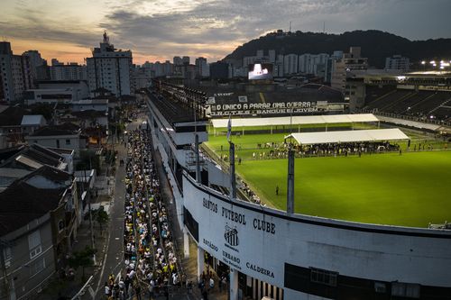 People wait in line to enter Vila Belmiro stadium where Pele, the late Brazilian soccer great lies in state in Santos, Brazil, Monday, Jan. 2, 2023 