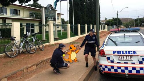 Queensland Police escorting a Charmander from a local primary school in Mount Isa. (Qld Police)