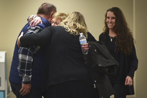 Lynette Johnson hugs friends after the execution is complete in Sioux Falls, South Dakota.