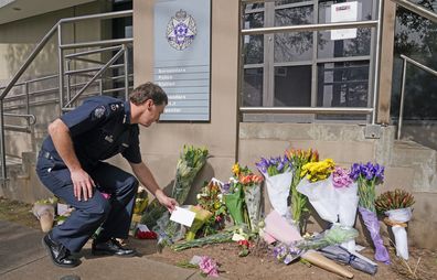 Victoria Police Deputy Commissioner Shane Patton lays a tribute at Boroondara Police near the Chandler Highway in the suburb of Kew in Melbourne, Thursday, April 23, 2020. Four police officers have died in a horror crash involving a truck on Melbourne's Eastern Freeway. (AAP Image/Scott Barbour) NO ARCHIVING