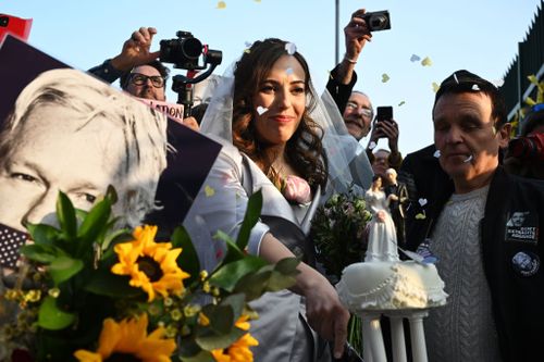 Stella Moris cuts a wedding cake given by supporters outside Belmarsh prison after marrying WikiLeaks founder Julian Assange.