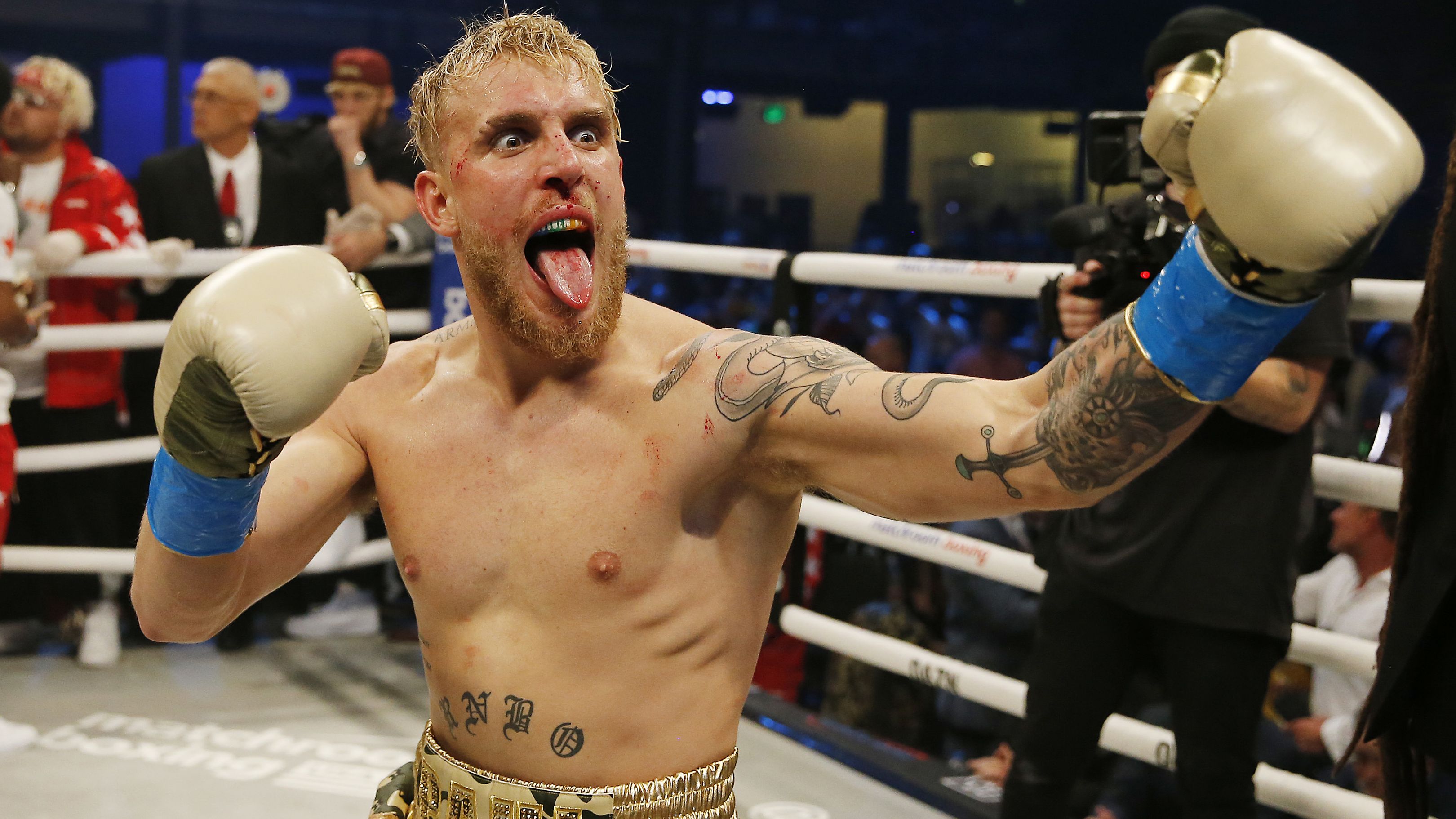Jake Paul celebrates after defeating AnEsonGib in a first round knockout.