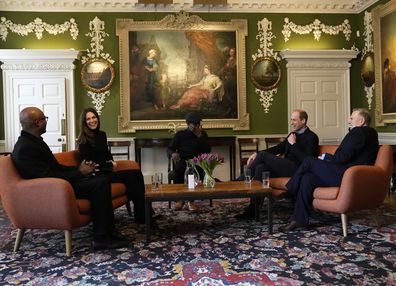 Prince William (second right) and Kate Middleton, the Duchess of Cambridge (second left) listen to Britain's former track and field athlete Kriss Akabusi, left, during a visit the Foundling Museum in London, Wednesday, Jan. 19, 2022.
