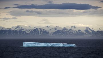 An iceberg floats past Bylot Island in the Canadian Arctic Archipelago, with marine scientists now discovering  deep sinkholes in the seafloor.