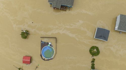 Home and structures are flooded near Quicksand, Ky., Thursday, July 28, 2022. Heavy rains have caused flash flooding and mudslides as storms pound parts of central Appalachia. Kentucky Gov. Andy Beshear says it's some of the worst flooding in state history. (Ryan C. Hermens/Lexington Herald-Leader via AP)