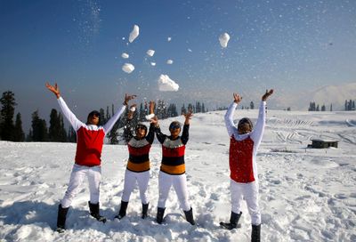 Indian tourists play with snow at Kongdoori tourist resort in Gulmarg north of Kashmir, some 60km from Srinagar, the summer capital of India’s Kashmir. 