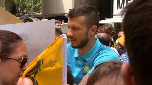 Team members signed autographs for eager fans waiting to congratulate them. (9NEWS)