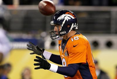 The first snap of the game clears Broncos quarterback Peyton Manning's head.