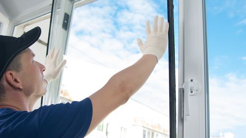 Man installing a double-glazed window