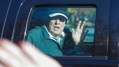 President Donald Trump waves to supporters as he departs after playing golf at the Trump National Golf Club in Sterling Va., Sunday Nov. 8, 2020. (AP Photo/Steve Helber)