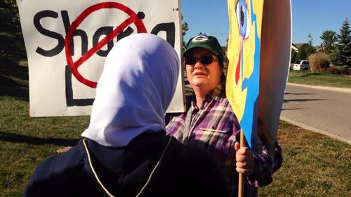 Ms Boutinkhar approaching the protester to request a hug. (Facebook/Cynthia Cox de Boutinkhar)