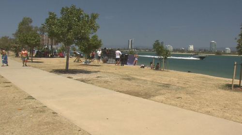 A man has died after being pulled unconscious from the water of a popular Gold Coast beach. The 54-year-old went swimming at The Spit this morning when he ran into trouble. Families nearby used picnic rugs to shelter the man as lifeguards and paramedics performed CPR. 