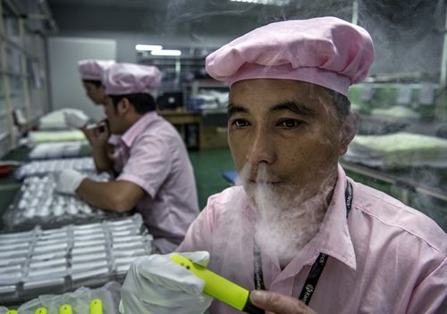 A worker tests an e-cigarette on the production line at Kanger Tech, one of China's leading manufacturers of vaping products,  in Shenzhen, China.