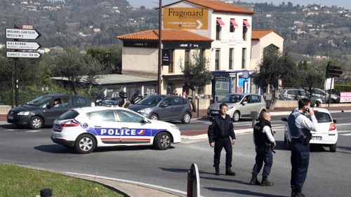Officers block the road following the shooting in Grasse. (AAP)