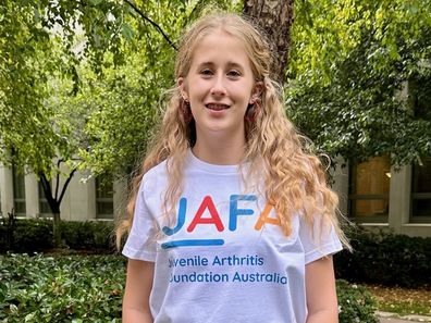 Laura Everson as a teen wearing a JAFA shirt.