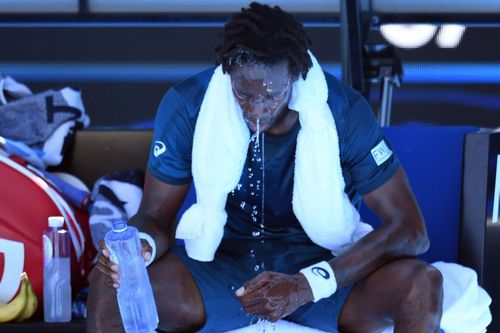 Gael Monfils of France cools down during a break in play against Novak Djokovic of Serbia during round two on day four of the Australian Open yesterday. (AAP)