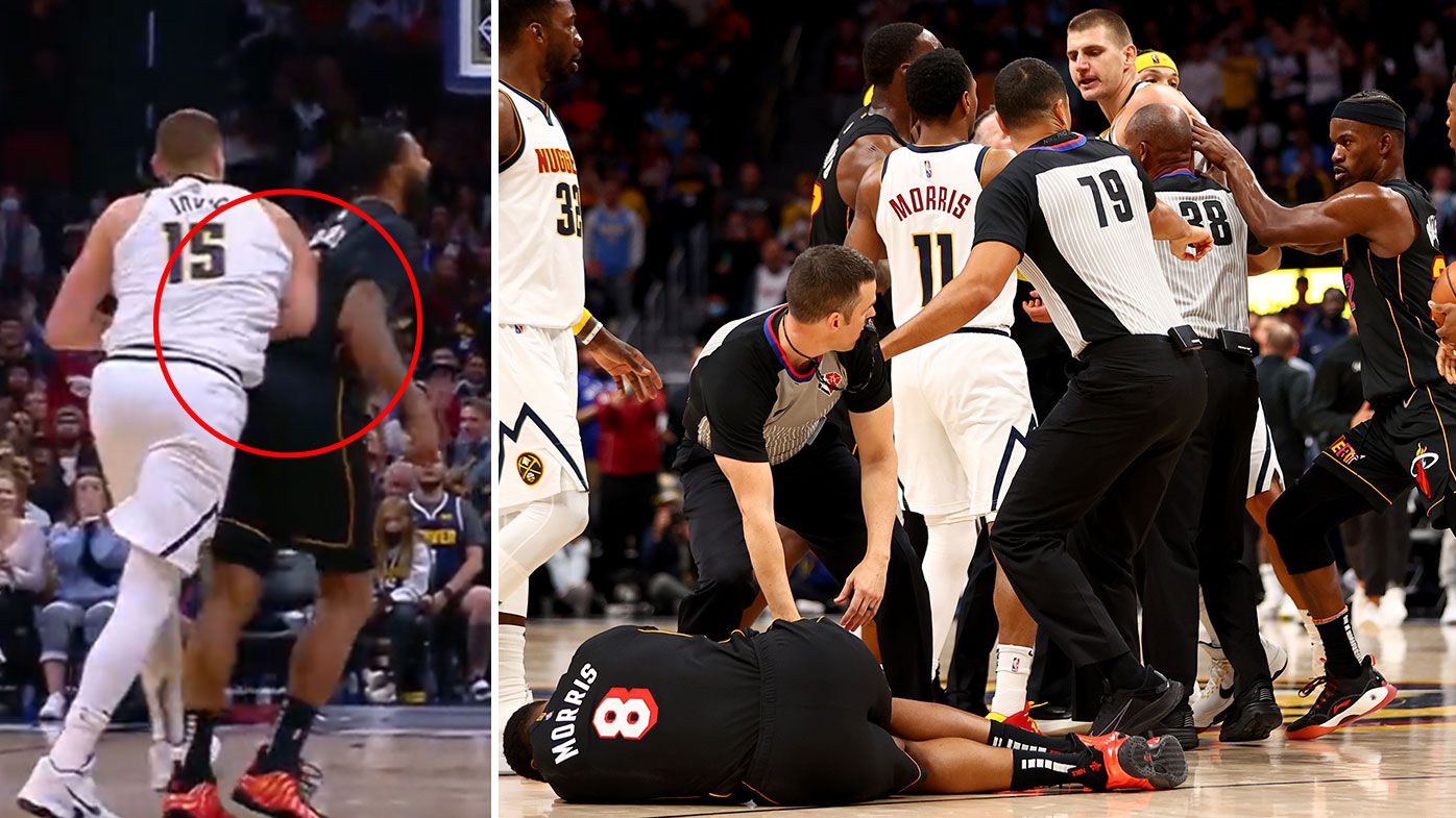 Markieff Morris #8 of the Miami Heat lays on the ground after being hit by Nikola Jokic #15 of the Denver Nuggets