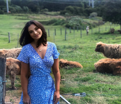 Woman posing in a pasture