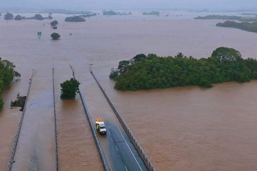 Record-level floods swallow major roads in far north Queensland