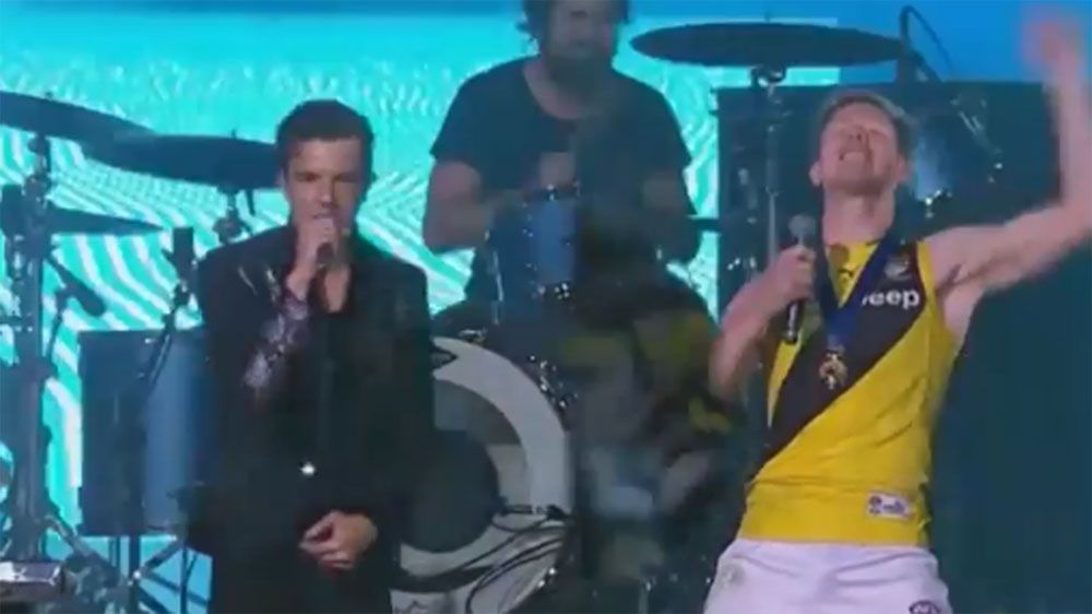 Jack Riewoldt jumps on stage with The Killers after winning AFL grand final